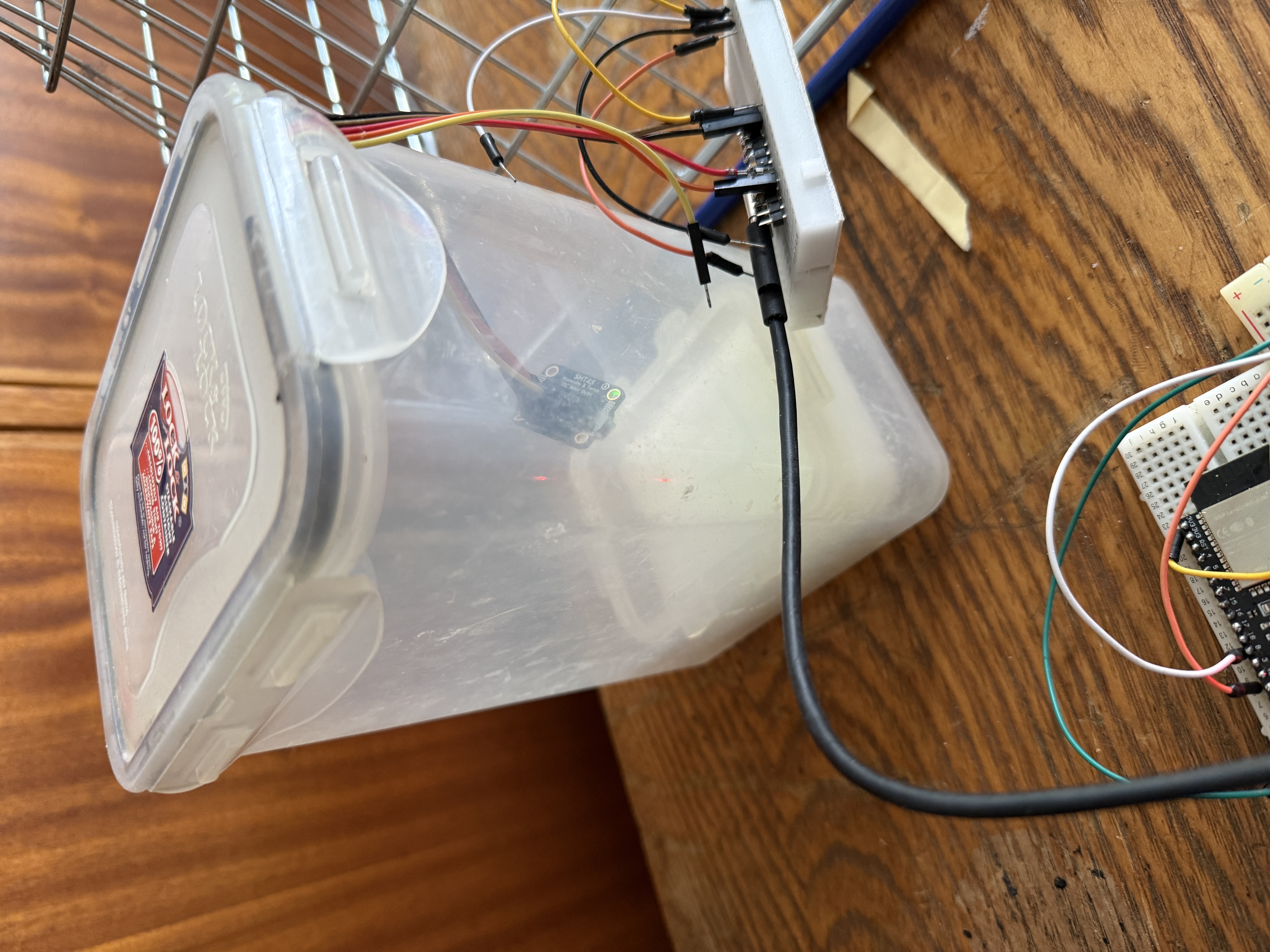 First attempt: plastic Tupperware container with table salt, wires through the side