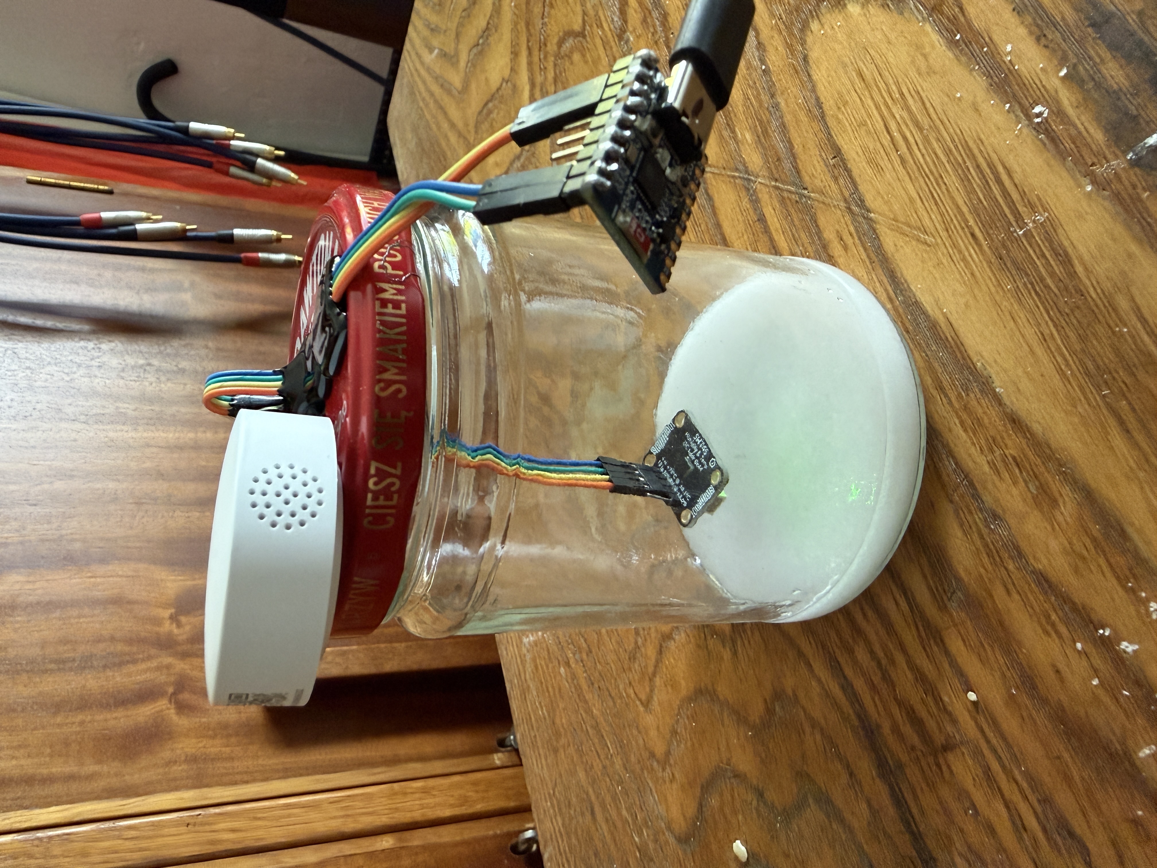 Final calibration chamber: glass jar, pure NaCl paste, SHT45 suspended on Dupont wires through hot-glued lid